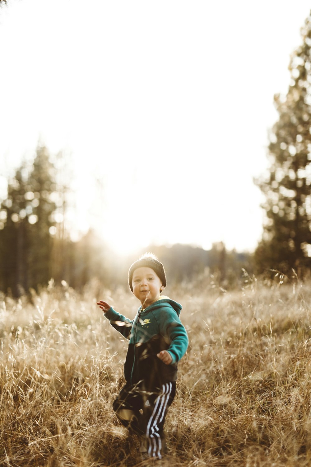 toddler standing on grass field