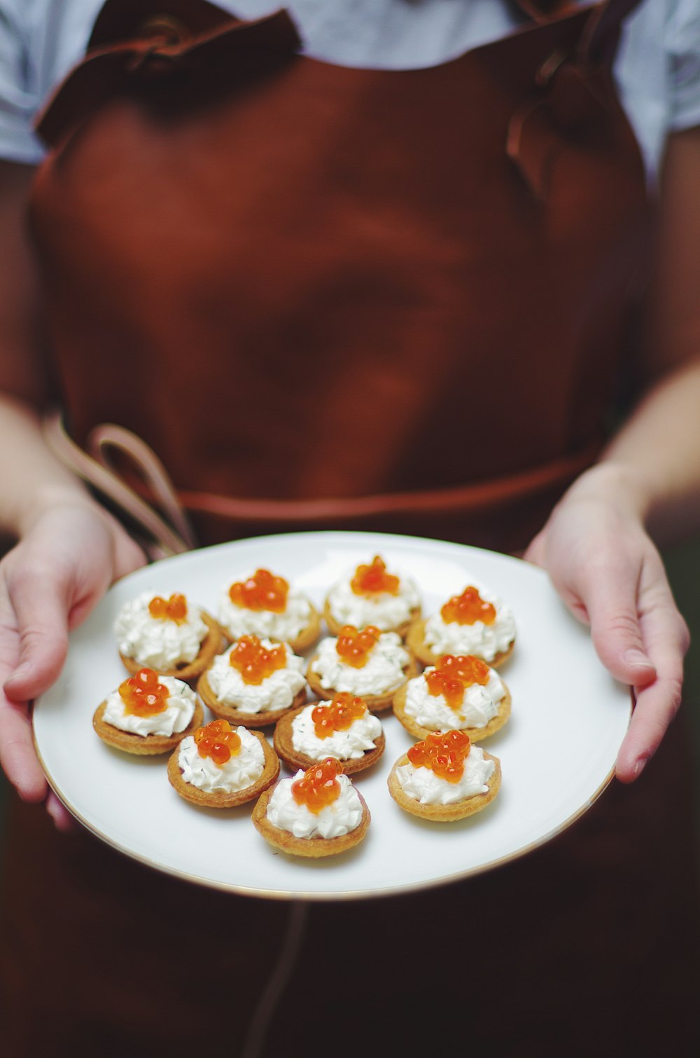 person holding tray of pastries