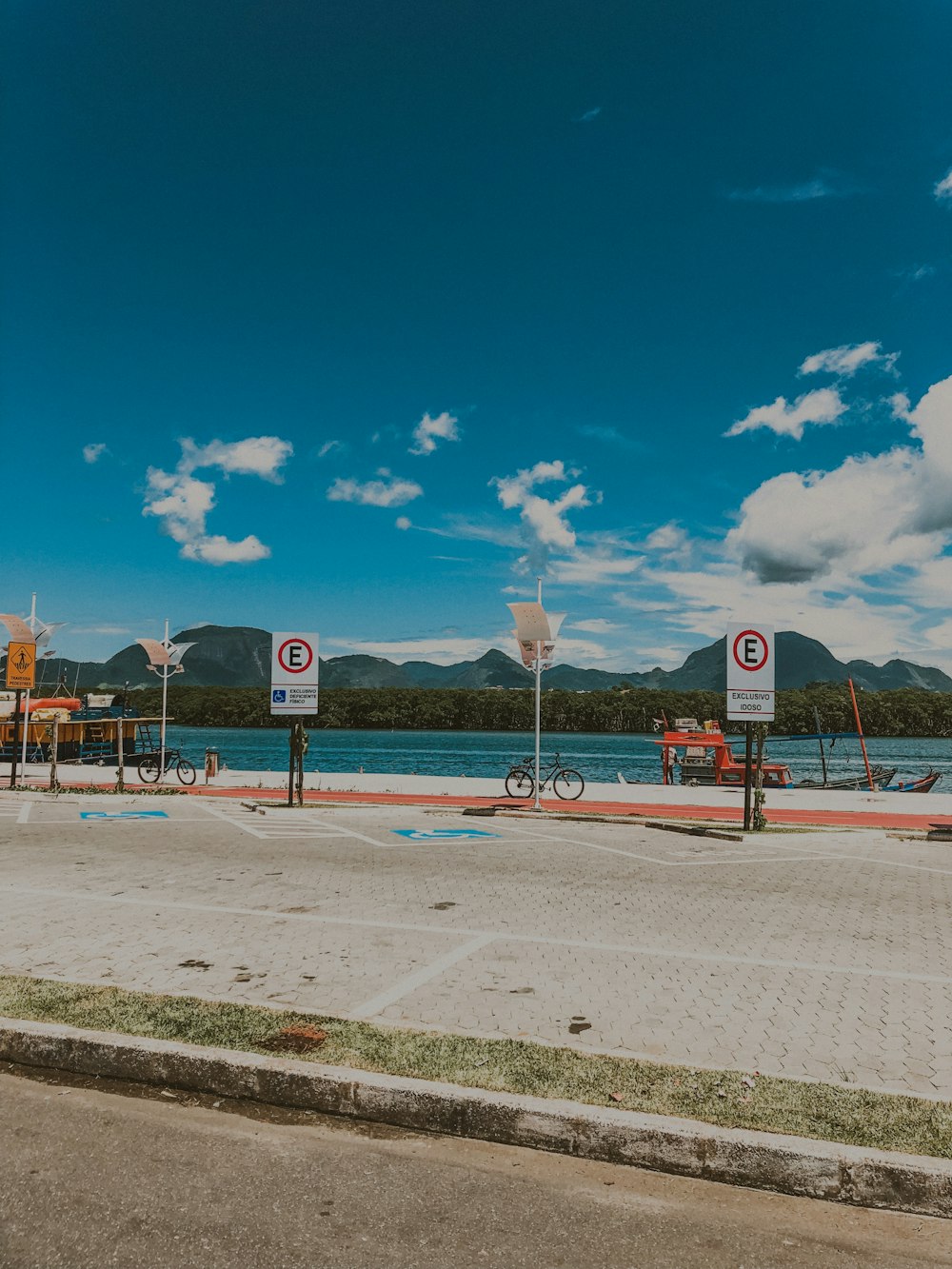 bike parked beside seashore signs during daytime