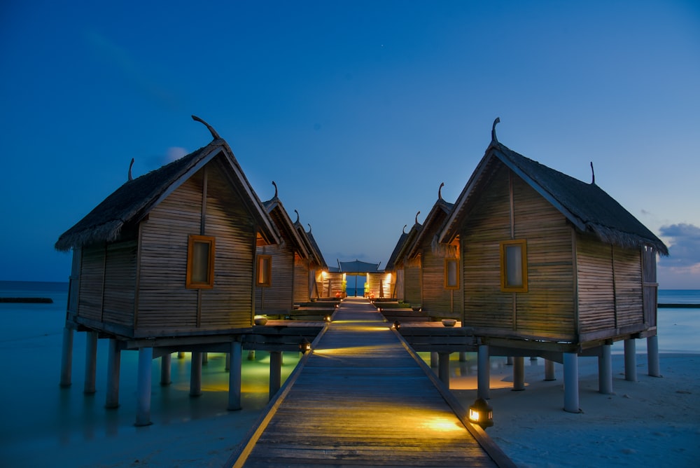 brown bamboo houses near seashore