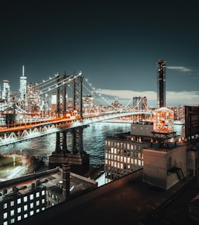 Night view of a city skyline highlighting bridges and buildings engineered by Avani Structural Engineering