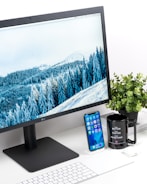 black LG monitor and white keyboard