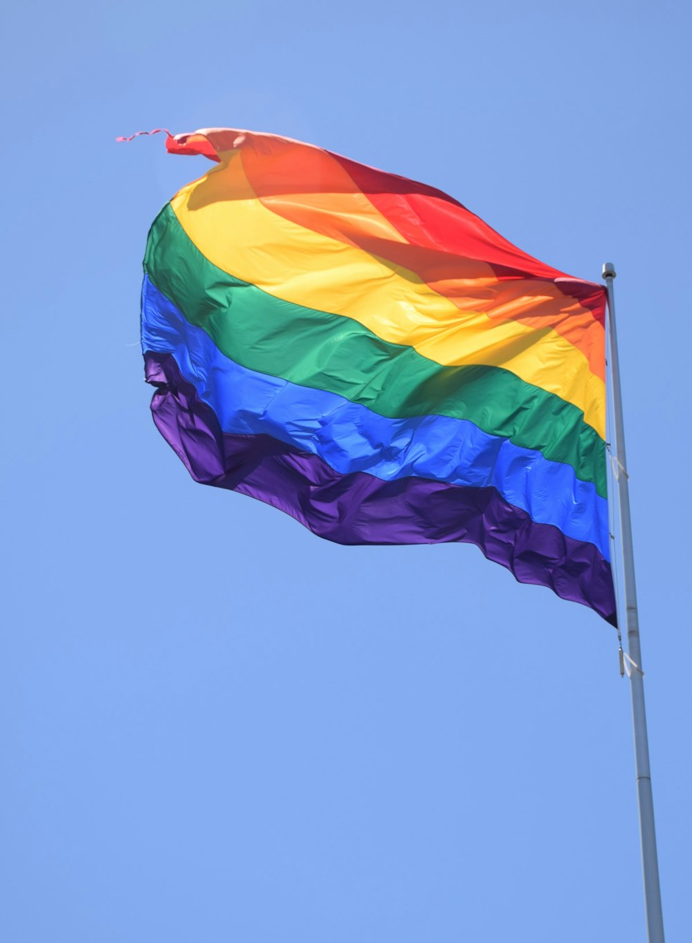 multicolored waving flag at daytime