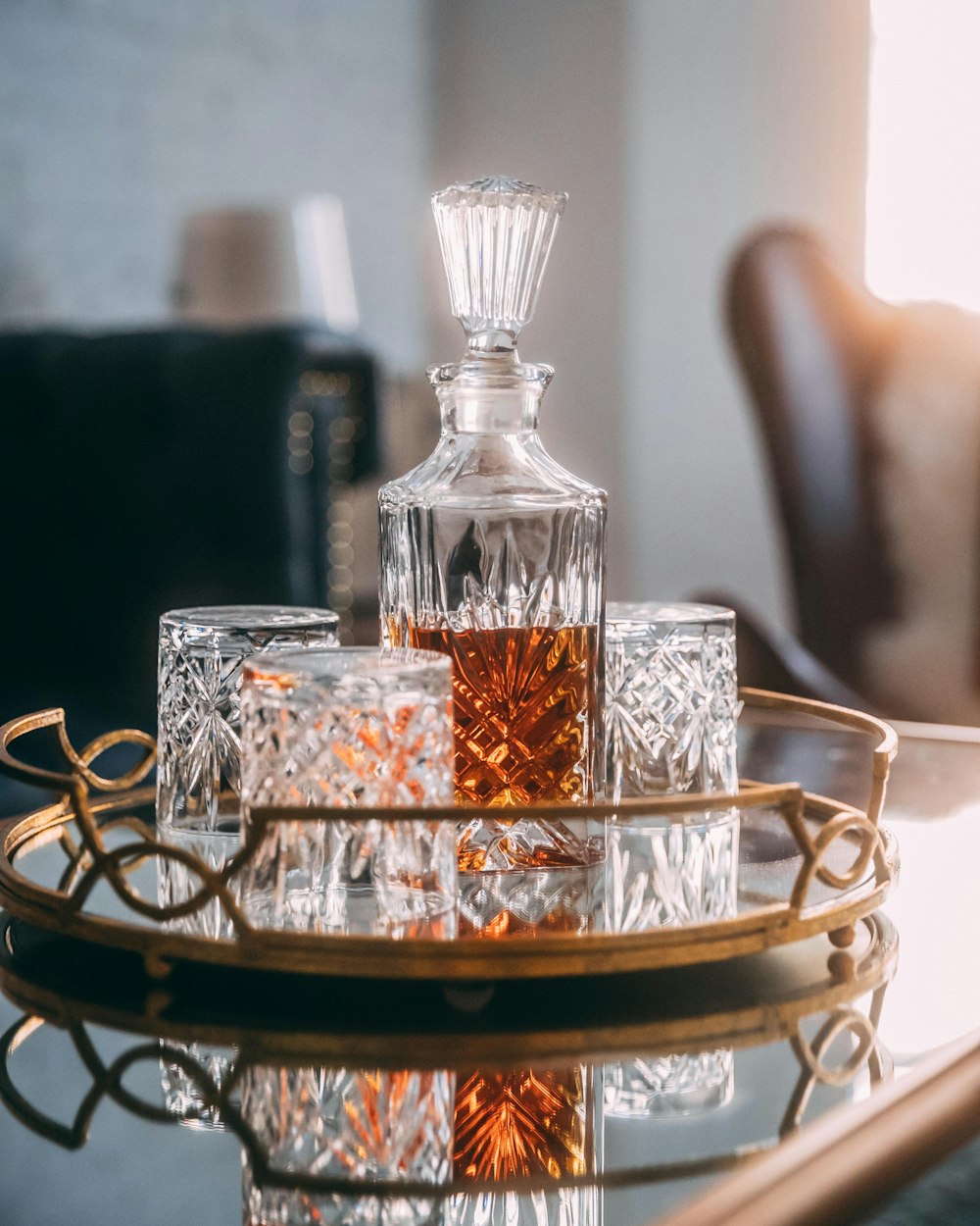 selective focus photography of liquor in decanter on mirror tray