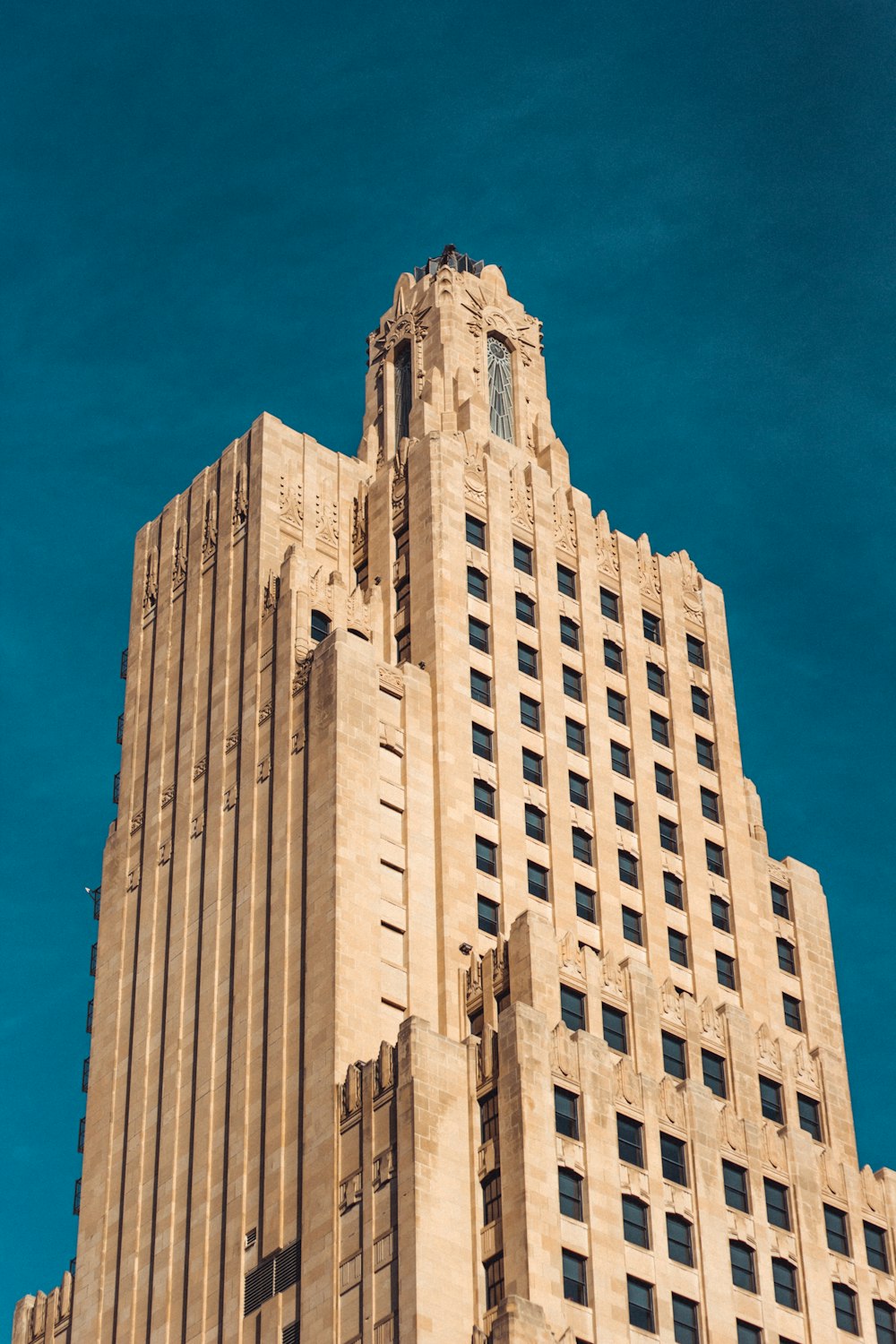 brown concrete high-rise building under blue sky