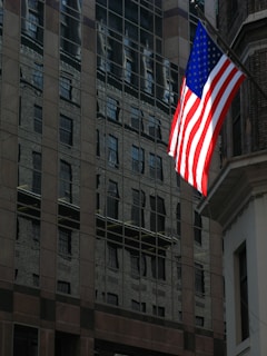 building with United States flag during daytime