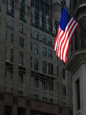 building with United States flag during daytime
