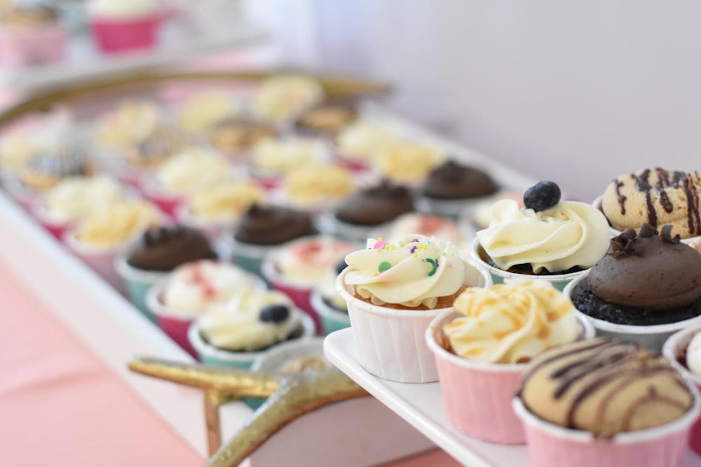 assorted-flavor cupcakes on selective focus photography