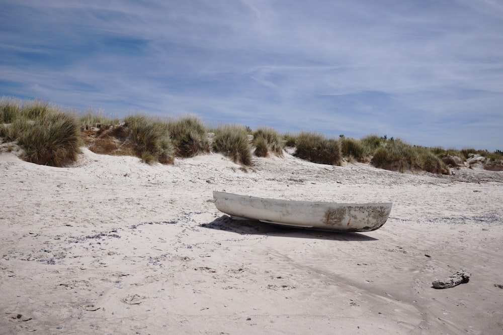 white boat on white sand