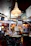 Cozy interior of l'orangerie restaurant with warm lighting and impressionist art on the walls.