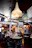 Cozy interior of l'orangerie restaurant with warm lighting and impressionist art on the walls.
