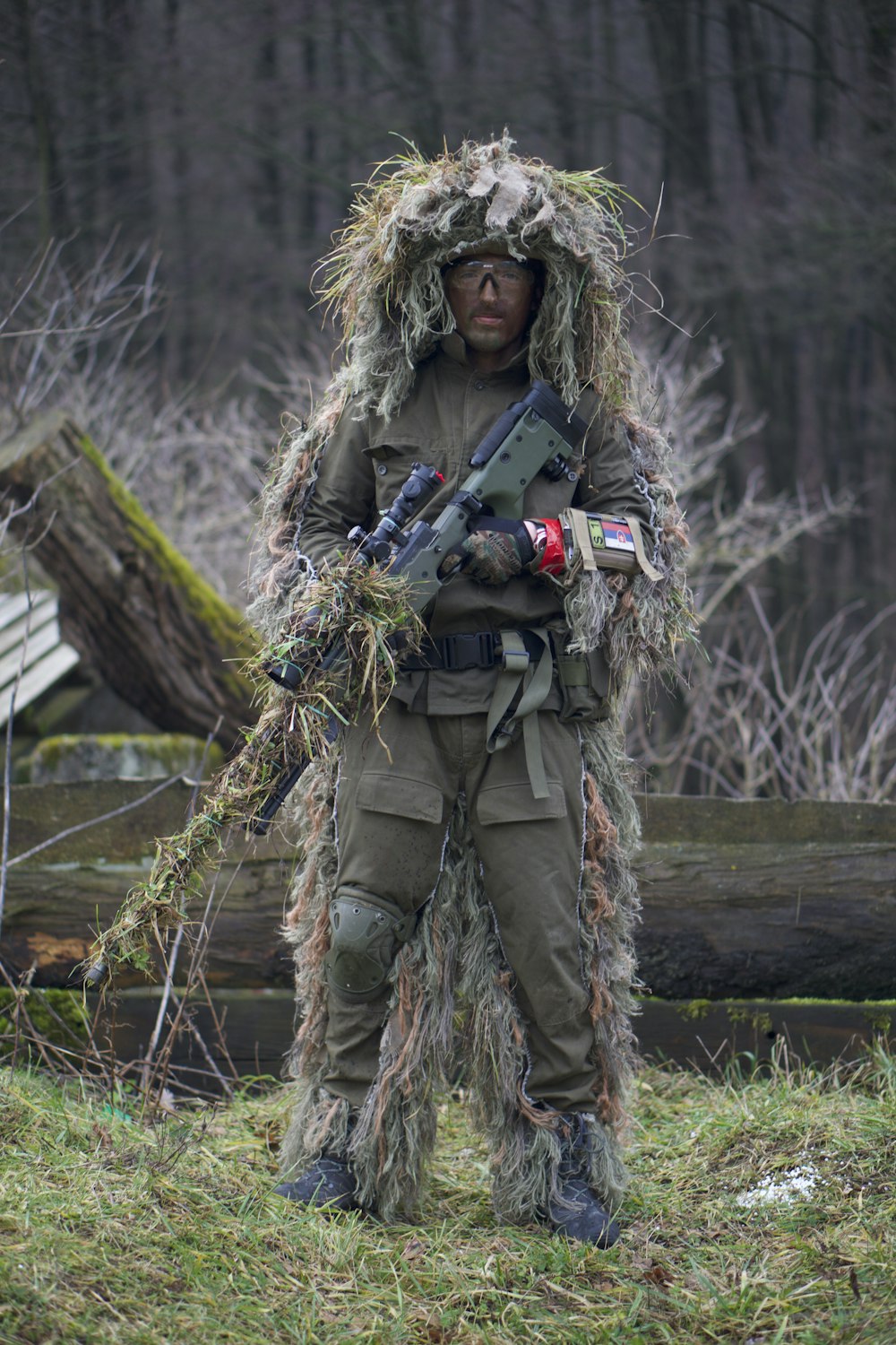 soldier covered with grass holding sniper rifle