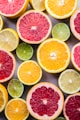 flat lay photography of sliced pomegranate, lime, and lemon