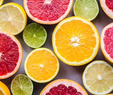 flat lay photography of sliced pomegranate, lime, and lemon