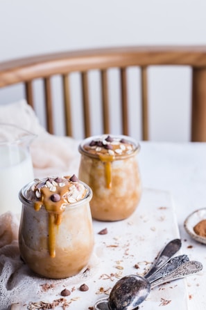 A jar of homemade dulce de leche with a rustic background.