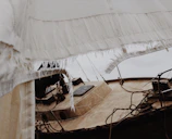 Canvas boat cover with custom stitching and repaired sections outdoors