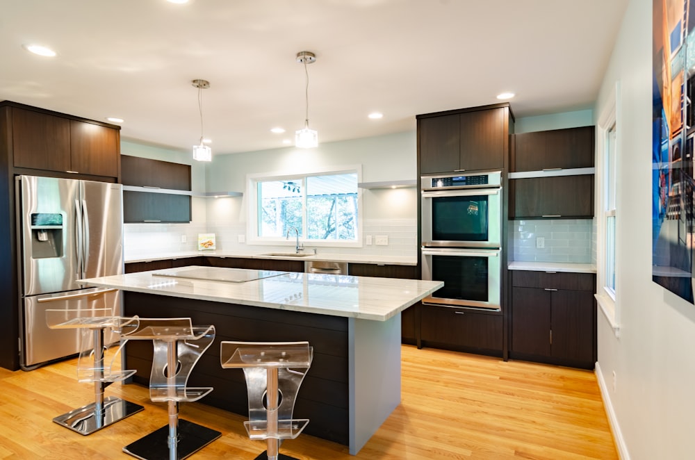 three clear glass bar stools