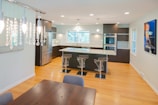 three clear glass bar stools