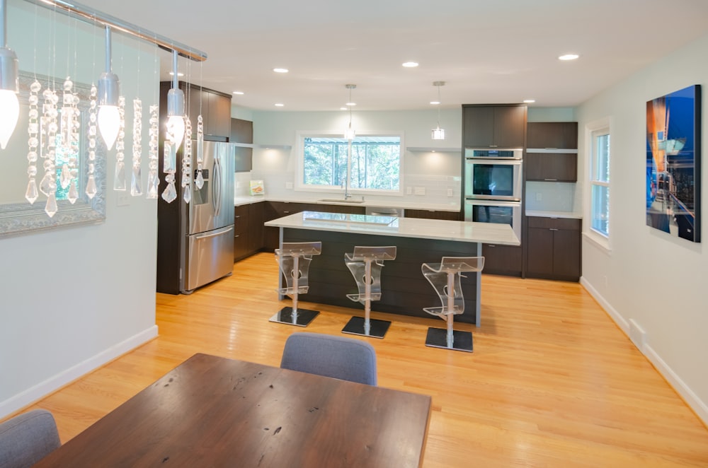 three clear glass bar stools