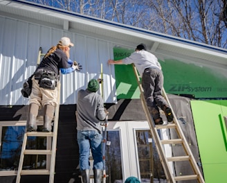 three person climbing on ladder