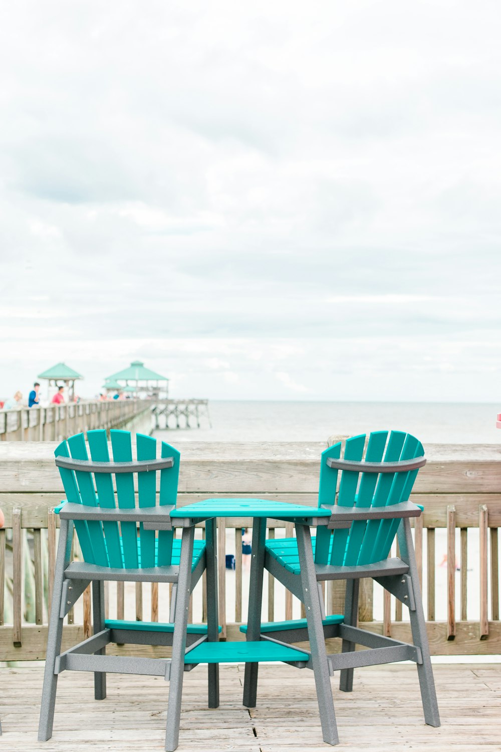 blue and gray wooden chair near shore