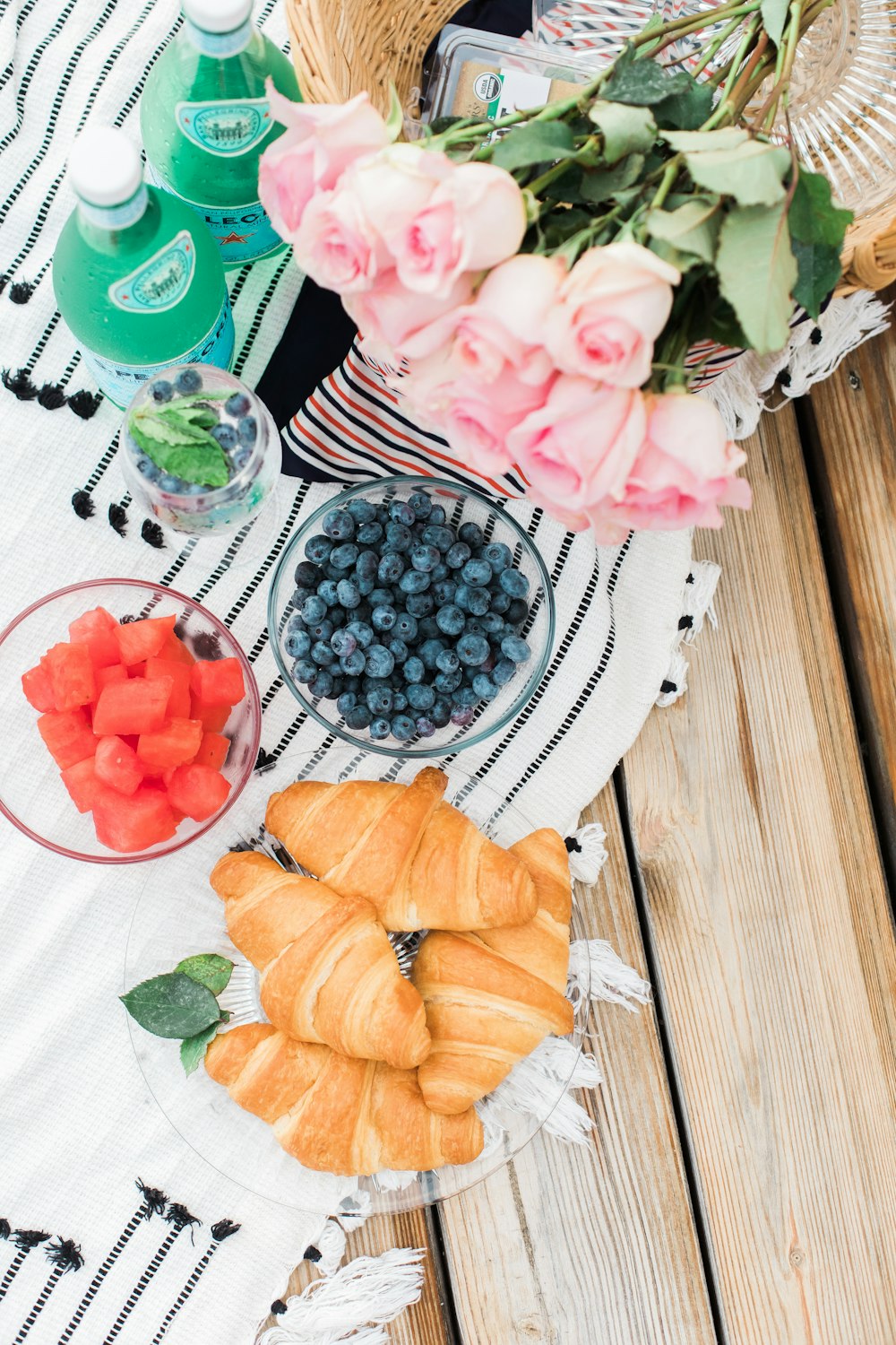 two bowl of fruits near plated breads