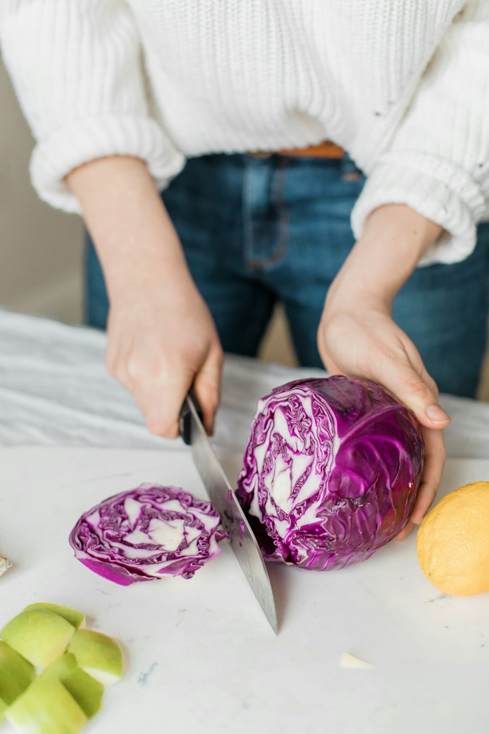 woman slicing purple vegetable