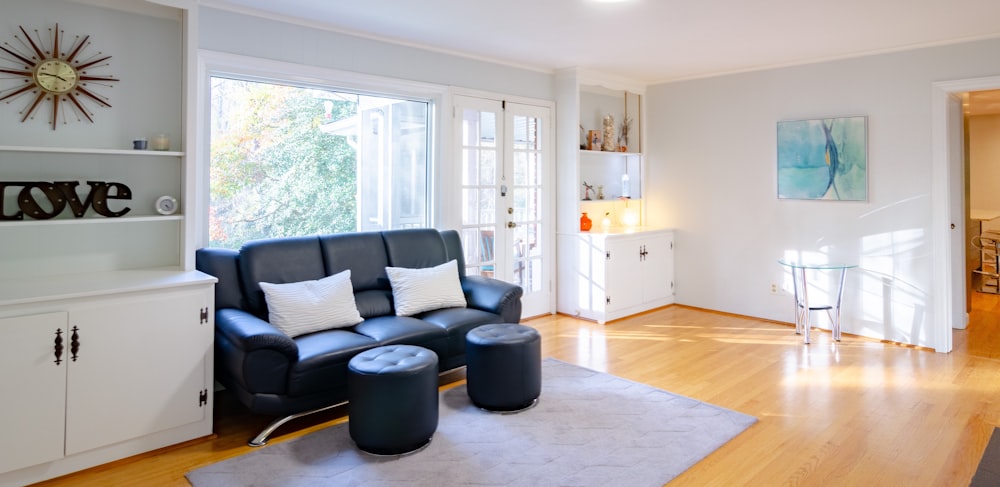 black leather sofa beside sideboard inside house