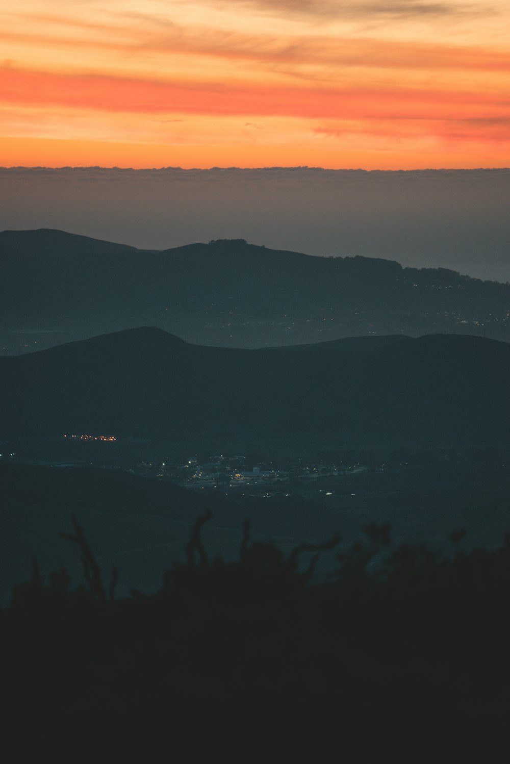 aerial photography of silhouettes of mountain under orange sky