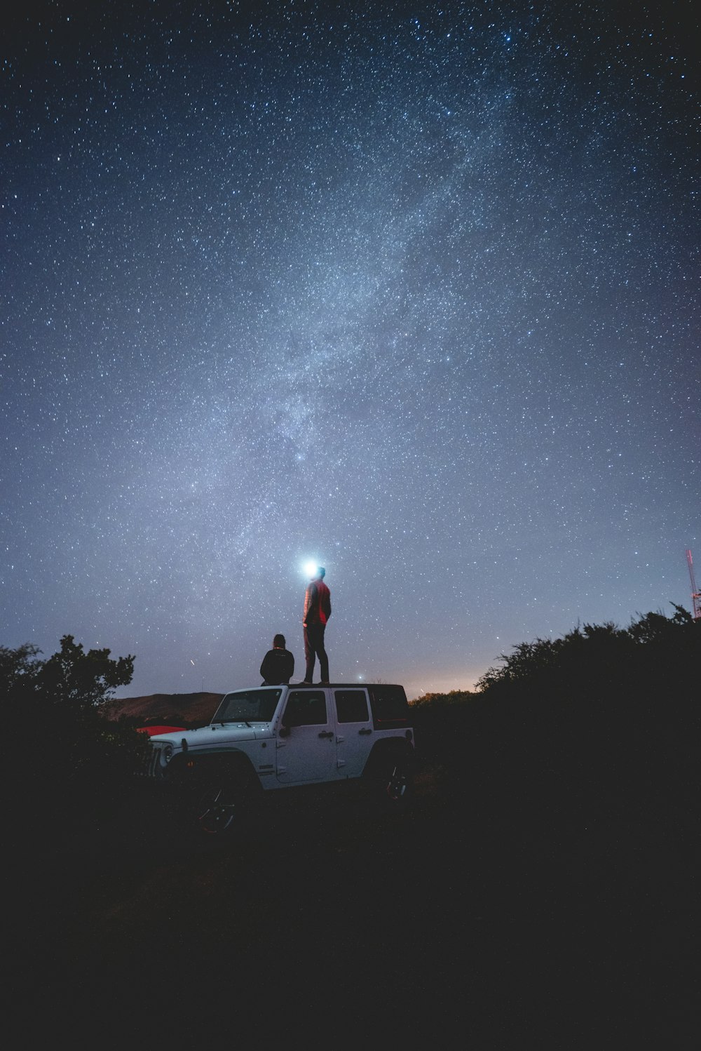 two person on white vehicle at night time