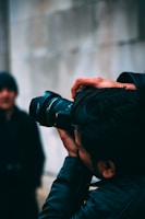man holding DSLR camera