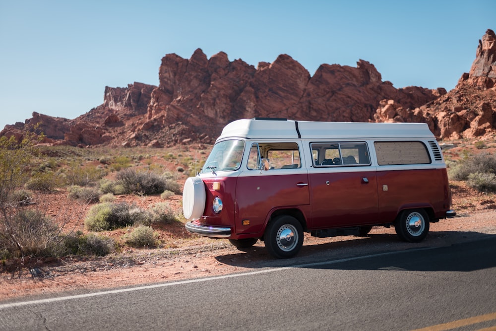 classic red and white bus parked beside road