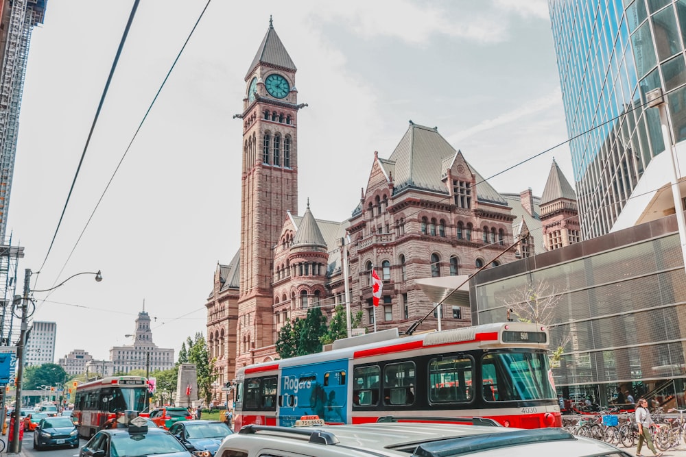 cars near brown clock tower