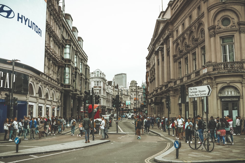 people walking on sidewalk surrounded by building