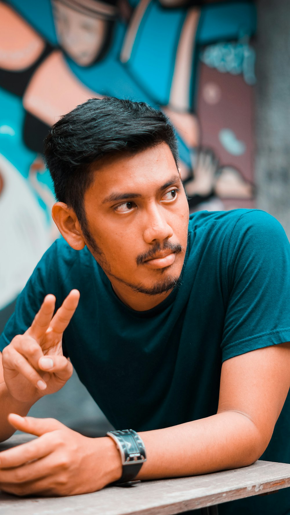 selective focus photography of man in green t-shirt