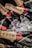 Several bottles of champagne are placed on ice, with labels featuring gold foil and red accents. The bottles partially submerged in ice give off a luxurious and celebratory vibe through the use of elegant design and chilled presentation.