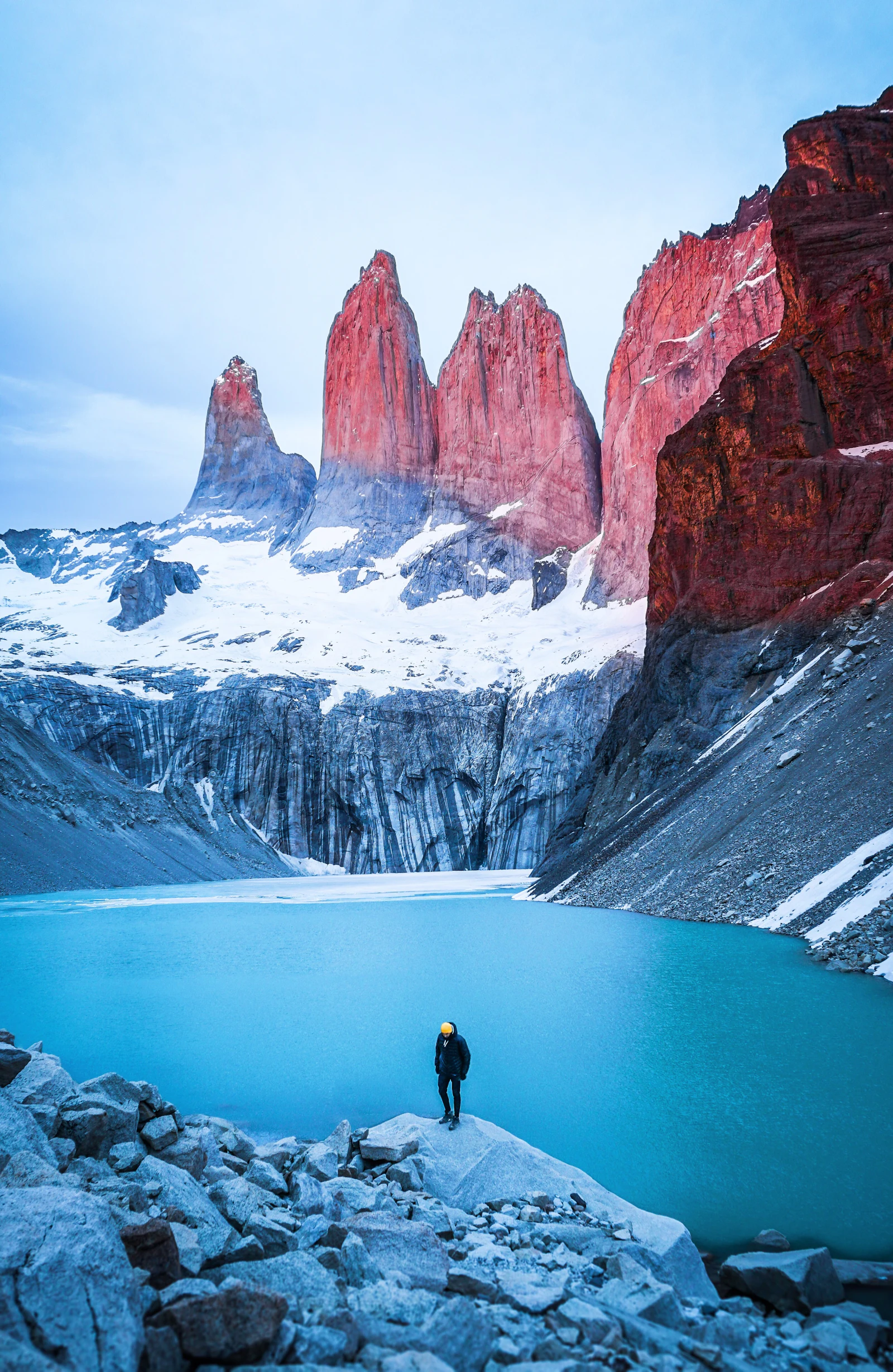 Person facing a lake and mountains