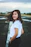 smiling woman standing on concrete floor in white t-shirt