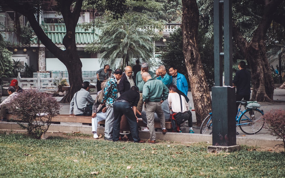 people gathering beside of sidewalk during daytime