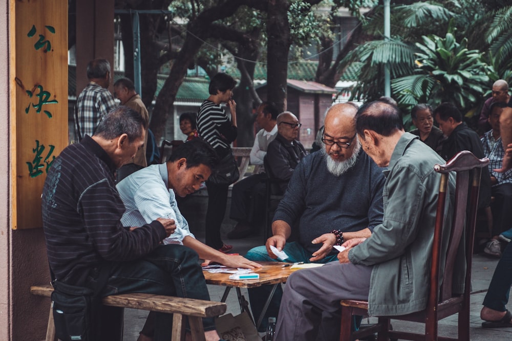 group of man playing cards