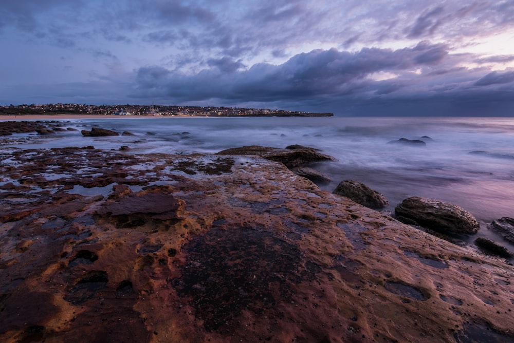 grey clouds over ocean and rock formations