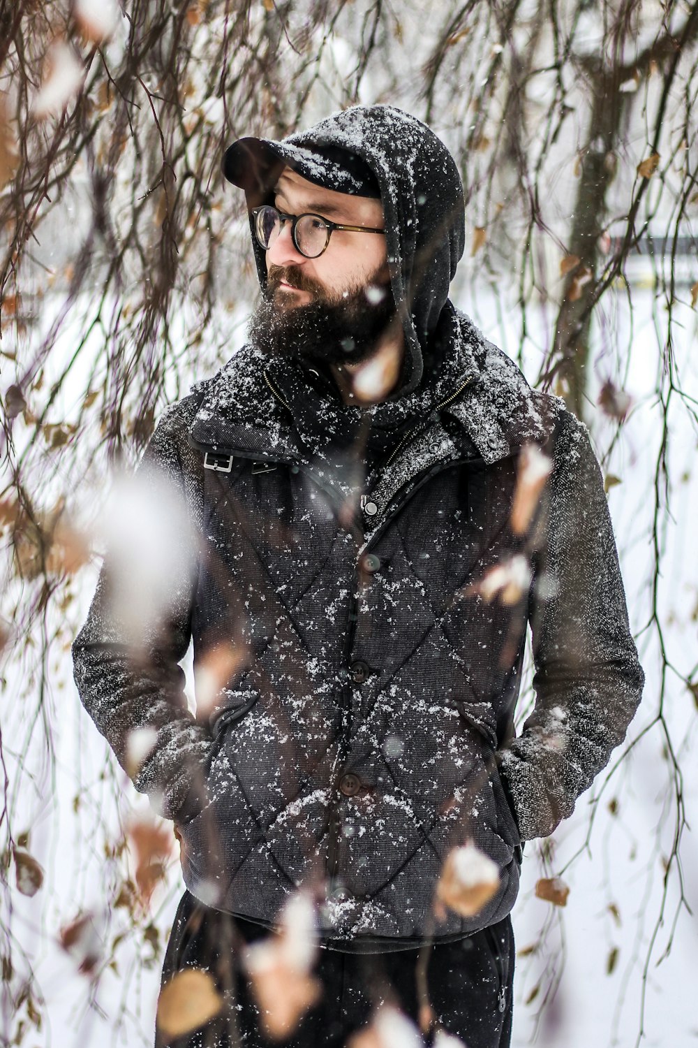 man in black jacket standing and looking sideways