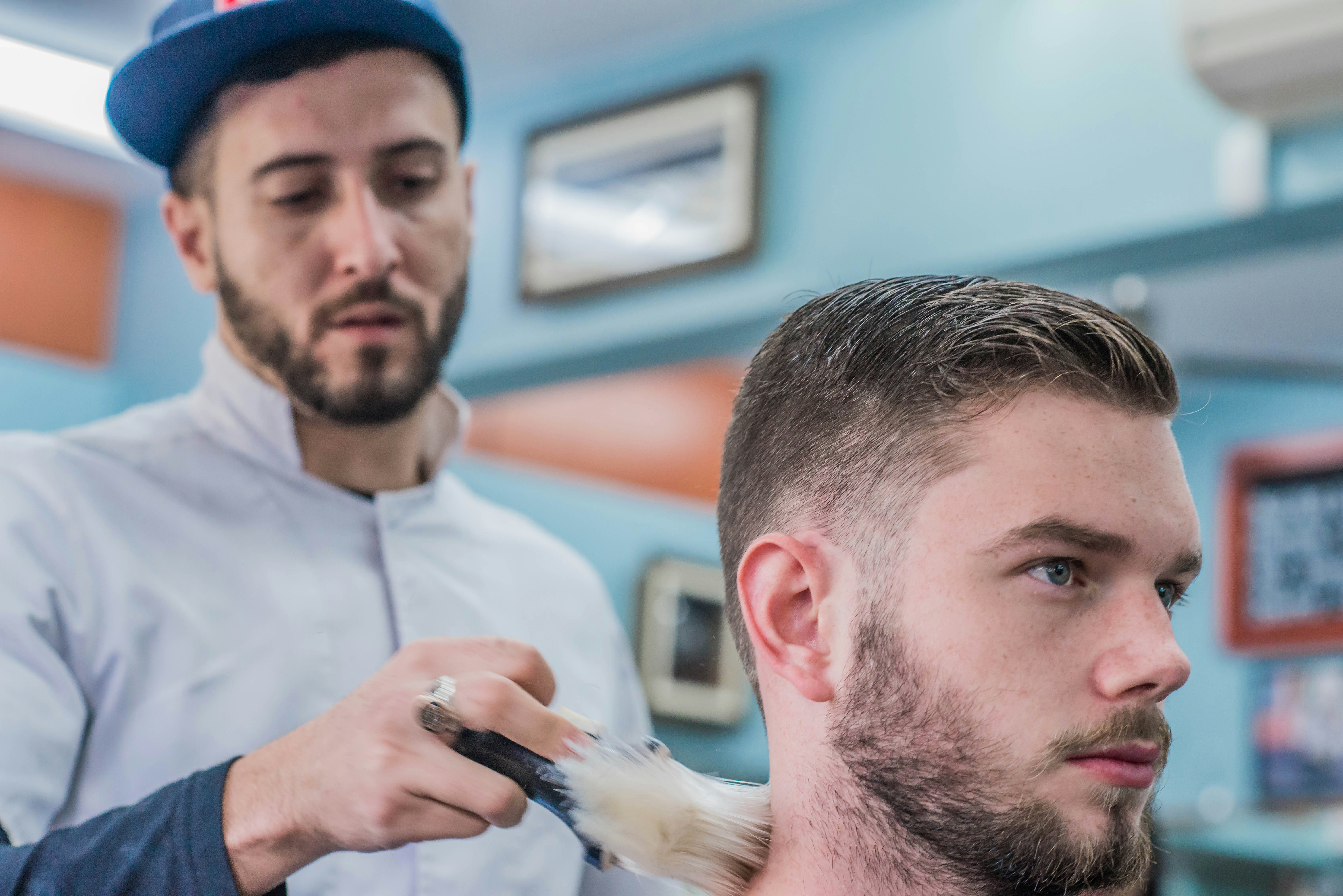 Barber styling a client's hair - Men's grooming expert