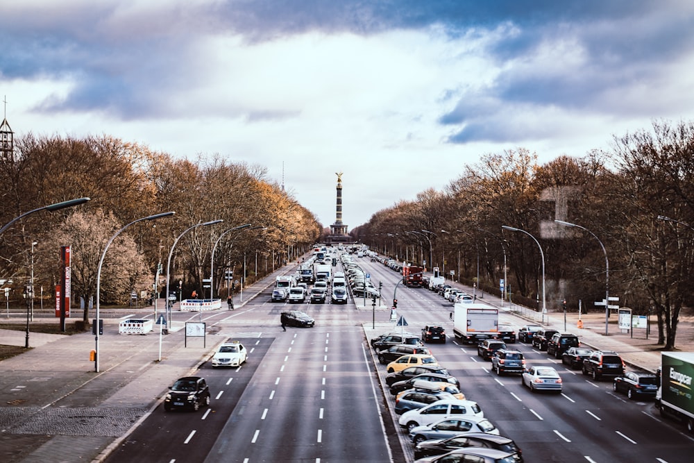 cars on road under nimbus clouds