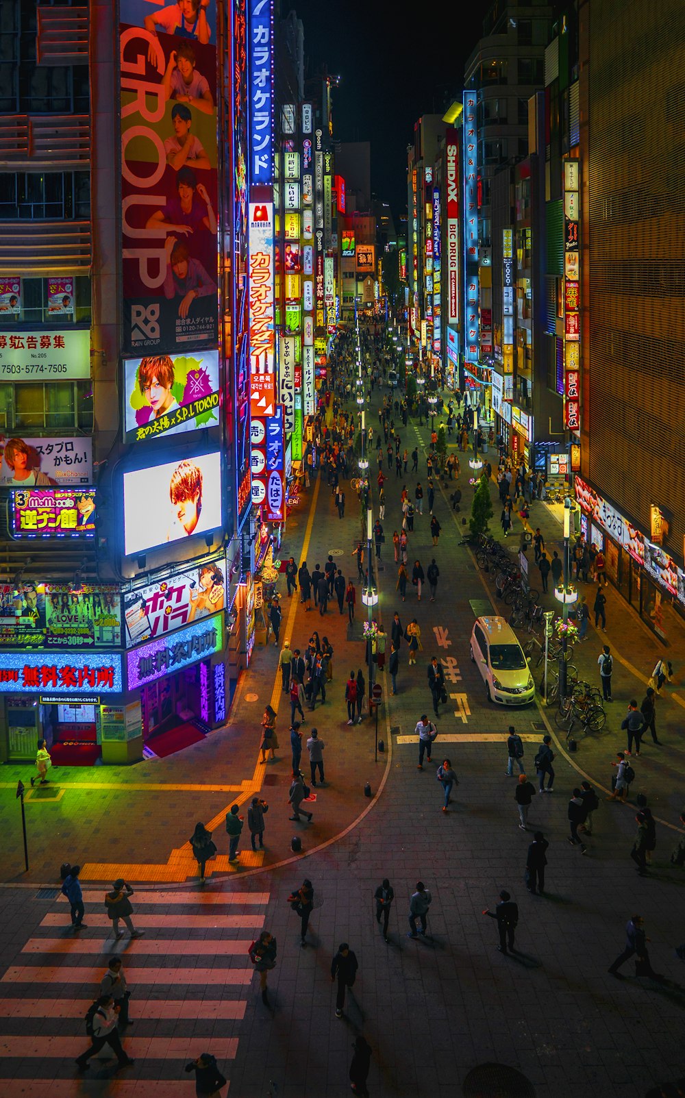 people walking on road at night