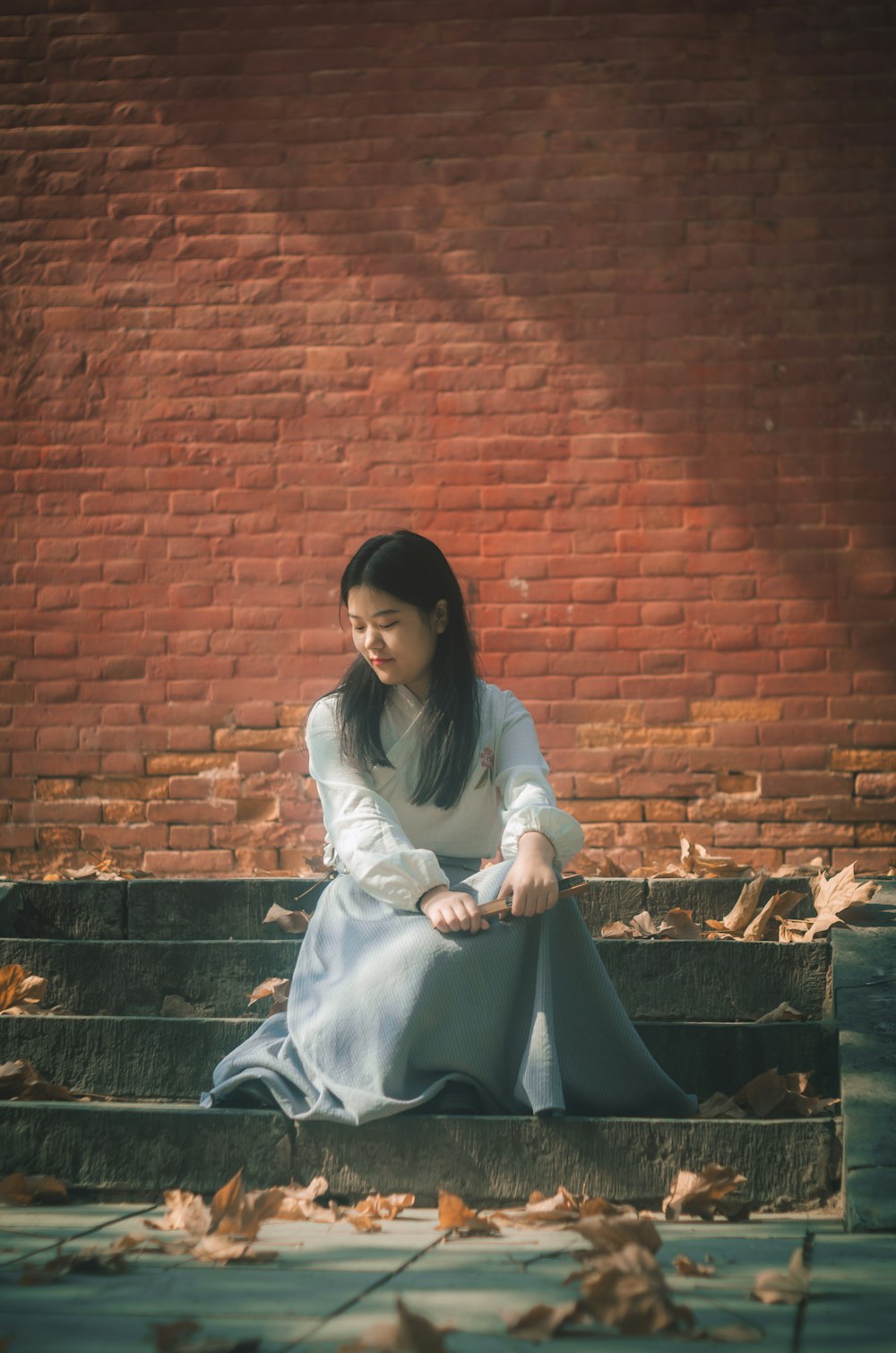 woman sitting near wall