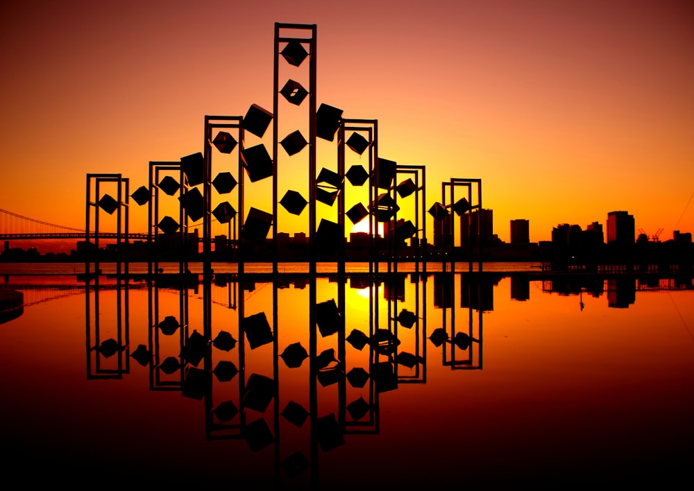 silhouette photography of an abstract building in front of cityscape