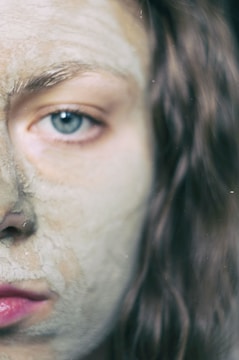 A close-up of volcanic clay being applied to skin.