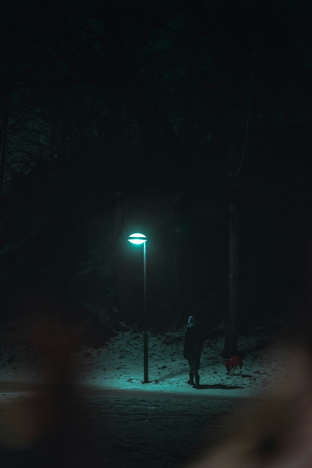 man standing underneath light