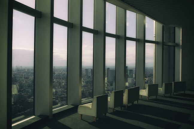 Serene lounge space with comfortable seating and large windows overlooking the city